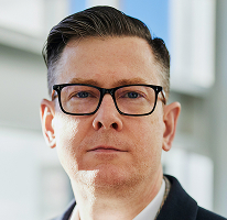 Photo d'Alexander Hughes, PDG dirigeant une plateforme de négoce en cryptomonnaies